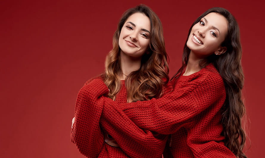 Two Women Wearing Red Hugging